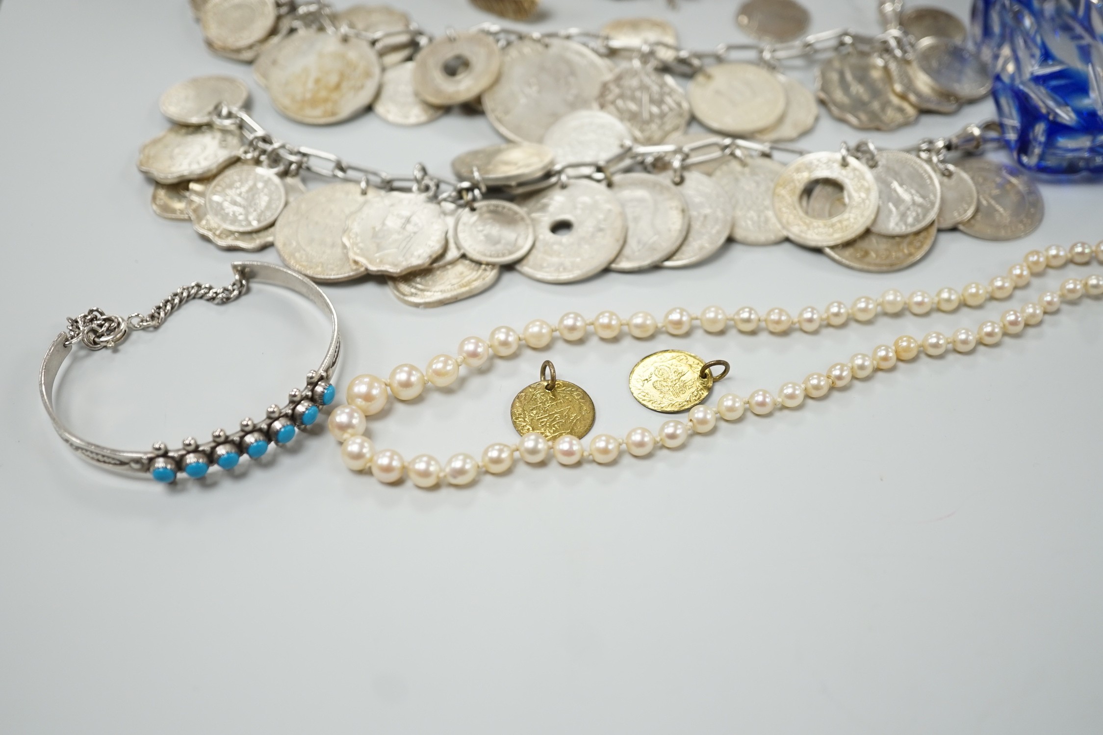 Mixed jewellery including a modern freshwater? pearl torsade necklace, 52cm, a Christian Dior 58 paste set brooch, two coin bracelets, a single strand cultured pearl necklace, mounted glass scent bottle, etc.